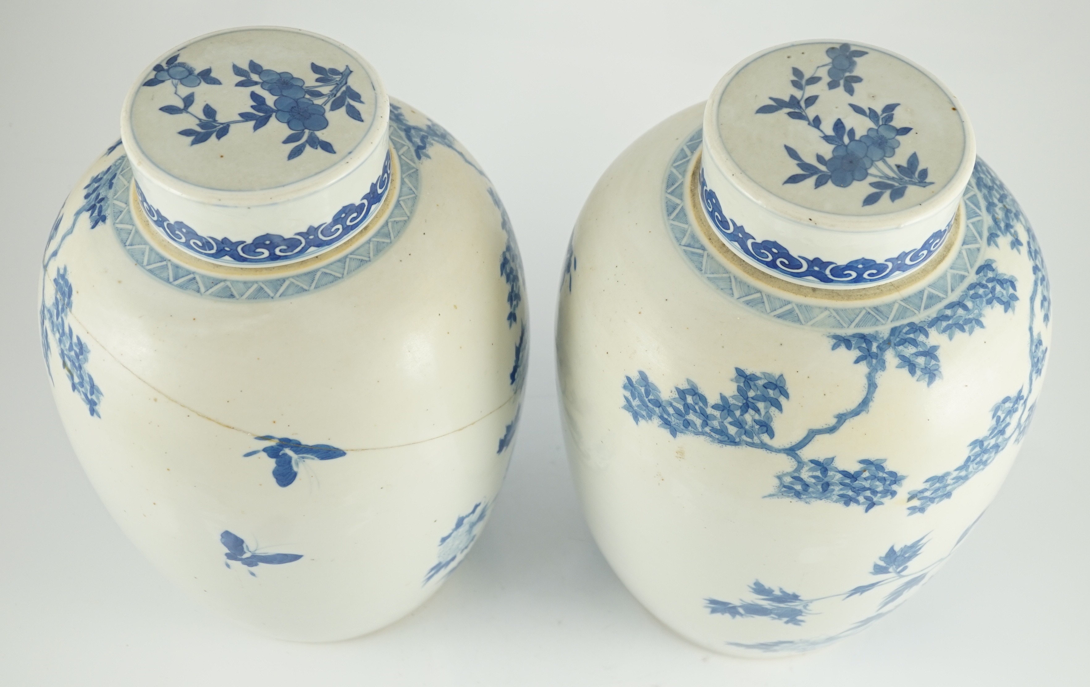 A pair of large Chinese blue and white ovoid jars and associated covers, 19th century, 34.5cm high, damage and repairs